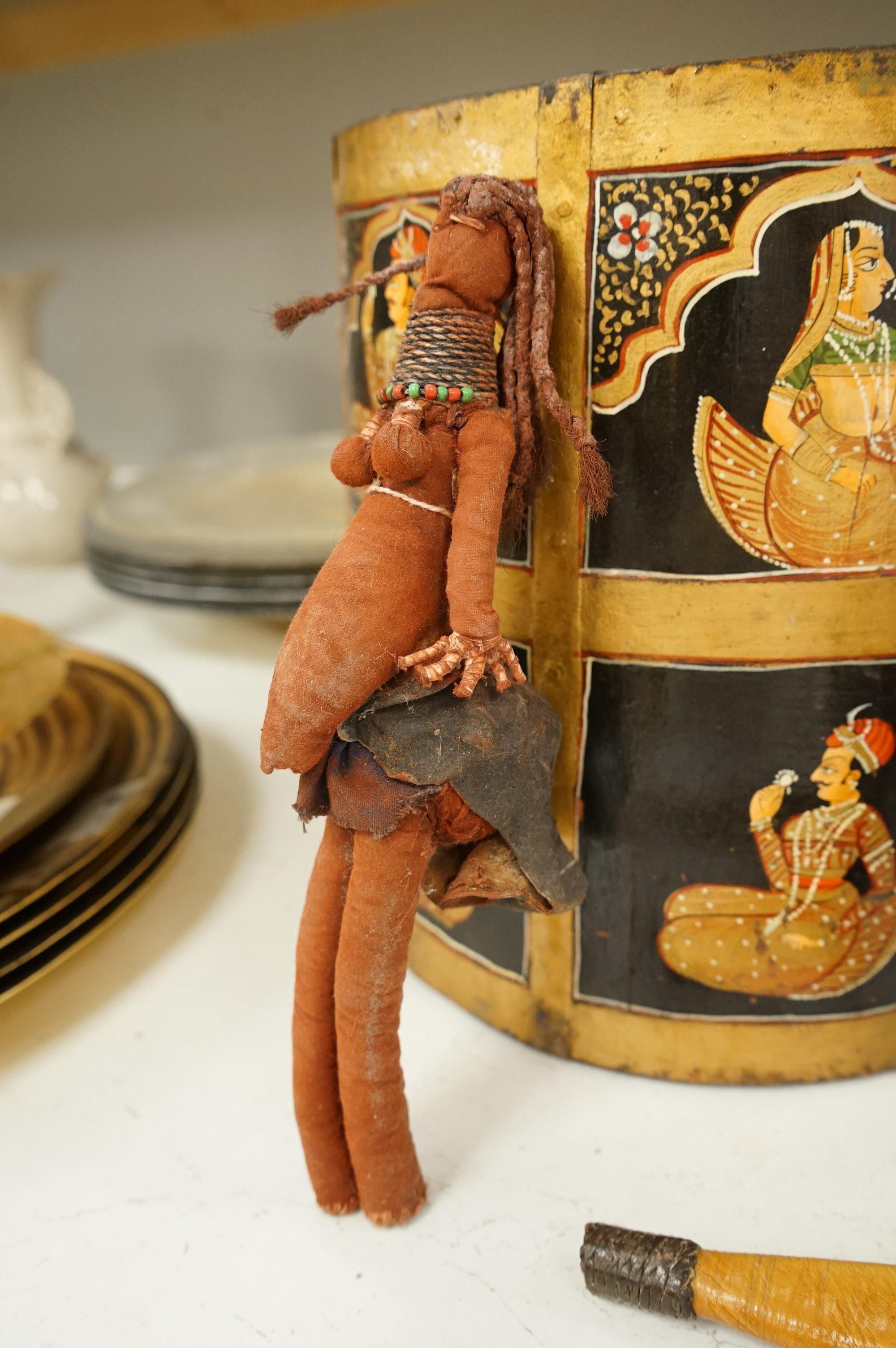 A collection of tribal and Asian collectables including a Tibetan prayer wheel, carvings, etc.